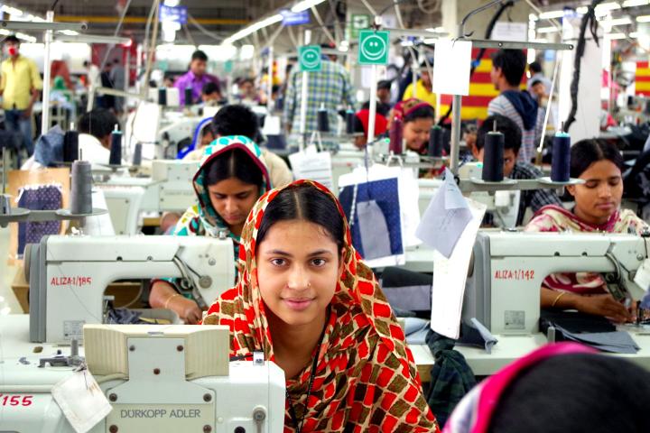 Photograph of garment workers in Bangladesh at sewing machines.