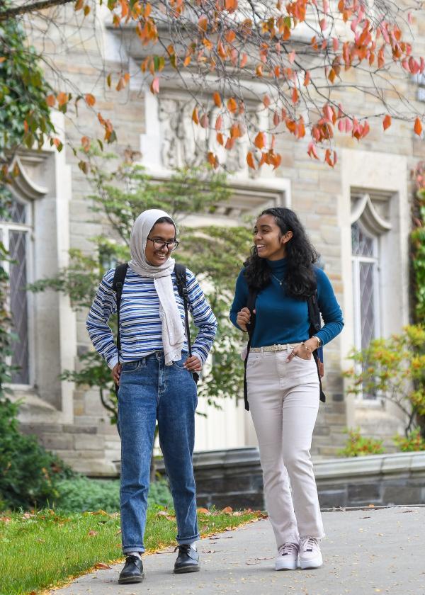 Two students walk on campus